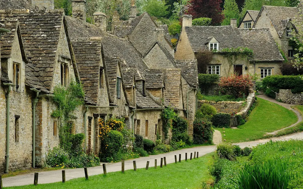 Arlington Row, a line of golden stone weavers' cottages in Bibury, in the Cotswolds.